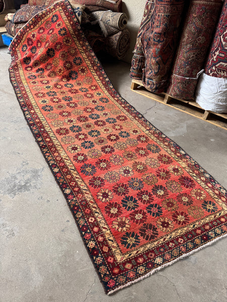 Vintage Persian runner rug with 70’s flower power floral motifs.