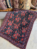 Diagonal view of floral themed small rug. 