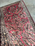 Vintage Persian Sarouk rug with romantic floral design.