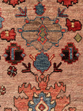 Close-up of aqua blue and coral color palette on Persian Heriz floor art.