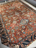 Antique Persian Heriz rug with terracotta and burnt sienna tones