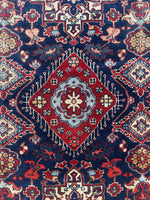 Detailed shot of berry red and ivory color blend in medallion.