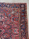Corner view of square antique rug sturdy wool construction Heriz.
