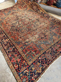Worn yet sturdy Persian Heriz rug ready for floor use.