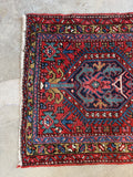 One end view of antique Heriz runner with border.