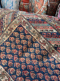 Midnight blue antique hallway runner with dense rust and terracotta paisley design.