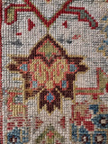 Close up of an authentic late 19th-century Persian wool runner with gentle, weathered wear across the surface.