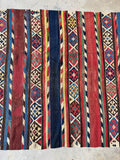 Tribal wool kilim rug with protective scorpion and dragon motifs woven in horizontal bands.