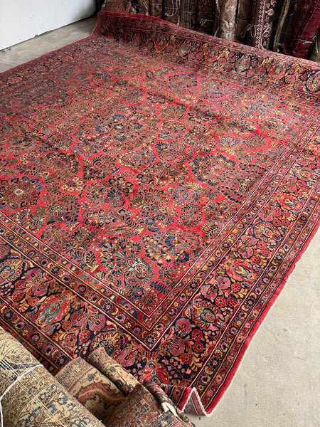 Handwoven Persian rug featuring berry red background