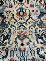 Indigo blue and coral details on a Ferahan rug