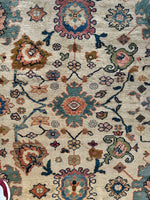 Timeless vintage rug with ivory background and colorful patterns.