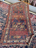 Handmade Persian Bidjar rug with an irregular width ranging from 4’3” to 4’9”.