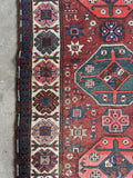 Tribal runner with ivory border decorated in love and unity motifs.