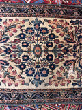Floral spray pattern Lilihan mat close-up shot focusing on the central medallion-like arrangement of stylized rosettes and vines.