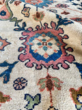 Handcrafted 19th-century rug with vivid floral and paisley design.