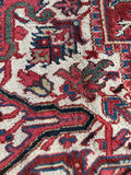 Large geometric Persian rug. Antique 1920s Heriz carpet with tribal artwork, uncommon medallion border, and vibrant natural colors.