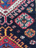 Diamond medallion with surrounding tribal ornamentation.