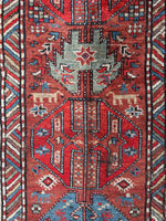 Close-up of Kazak runner with S-hook motifs for protection against the evil eye.