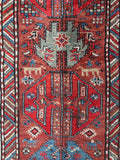 Close-up of Kazak runner with S-hook motifs for protection against the evil eye.