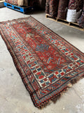 Antique Kazak runner with narrow field and multi-step medallions.