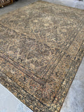 Antique Persian Kerman Lavar rug with neutral field and fine lattice design.