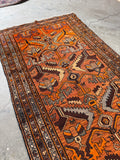 Graphic tribal pattern with bold lines and shapes.