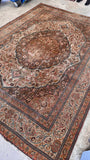 Warm brown and ivory palette of a large antique Persian Tabriz rug.