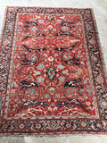 1920s Persian Heriz rug with scattered wear and dynamic allover design

