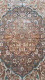 Antique Persian Tabriz rug in the 9x13 size range with an intricate floral medallion.