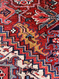 Antique Persian living room rug 8x11 with bold tribal-inspired Heriz design and durable wool pile.