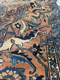 Antique Hamadan region rug with dynamic movement and intricate border motifs.