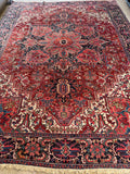 Vintage Persian tribal rug. Antique Heriz carpet woven in Northwest Persia with bold geometry, full pile, and remarkable condition.