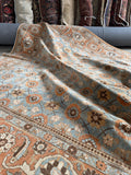 Handmade antique Persian rug from Tabriz measuring 7 x 10 with powder blue field and floral allover pattern.