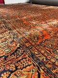 Extra large salmon coral antique Persian rug with allover floral design.