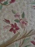 Closer up view of handwoven French Aubusson tapestry with romantic flowers, soft movement, and timeless European artistry.
