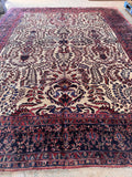 Oversized antique Persian Sarouk rug full view showcasing the balanced layout and dynamic sense of movement.