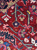 Close up of an Antique handwoven Persian Heriz rug with heavy wool and a bold central medallion.