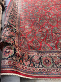 Densely knotted antique rug with a substantial weight and a healthy, glowing wool finish.