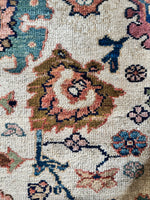 Large ivory ground rug with vibrant floral motifs and paisley border.