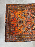 Ombre orange detail at one end of the rug.