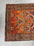 Ombre orange detail at one end of the rug.
