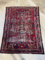 Full view of antique Persian Lilihan rug with berry red background and botanical design.
