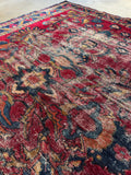 Section showing botanical pattern against berry red ground and love-worn areas.