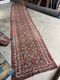 Nearly 19 foot antique Persian hallway runner with ivory border.
