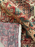 Vintage geometric Persian runner for hallway or kitchen with sturdy wool construction and tribal movement.