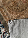 Underside view of French wall tapestry with detailed woven motifs and warm aged tones.