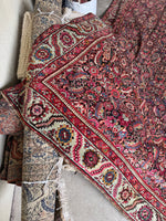 Stylized floral motifs along ivory border band