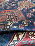 Close up view of wool texture in antique Caucasian runner.