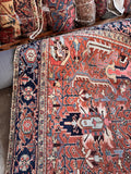 Vintage 1920s Northwest Persian rug overview showcasing rectilinear tribal art, deep navy borders, and warm plant-dyed wool tones.