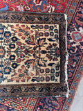 Ivory ground floral Persian accent rug flat lay perspective showing complete proportions and contrast with the dark patterned border.